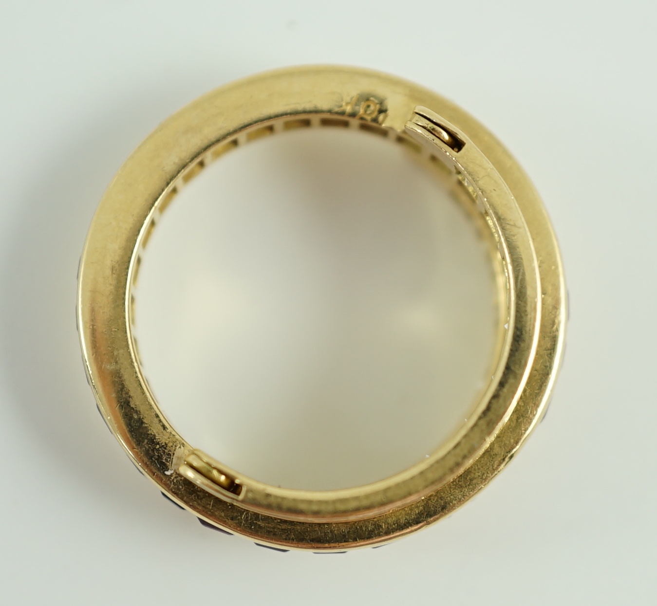 An 18k gold, ruby, sapphire and diamond set triple band swivel ring